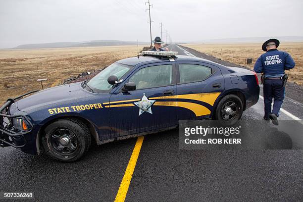 Oregon State Police officers monitor a closed area at a road checkpoint on Highway 78 approximately 4 miles from the Malheur Wildlife Refuge...