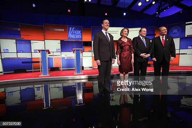 Republican presidential candidates Rick Santorum, Carly Fiorina, Mike Huckabee and Jim Gilmore pose for photographers prior to the Fox News - Google...