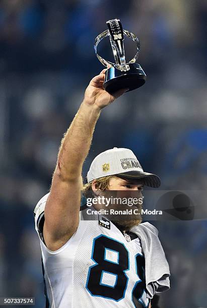 Greg Olsen of the Carolina Panthers holds the George Halas Trophy after winning the NFC Championship Game against the Arizona Cardinals at Bank of...