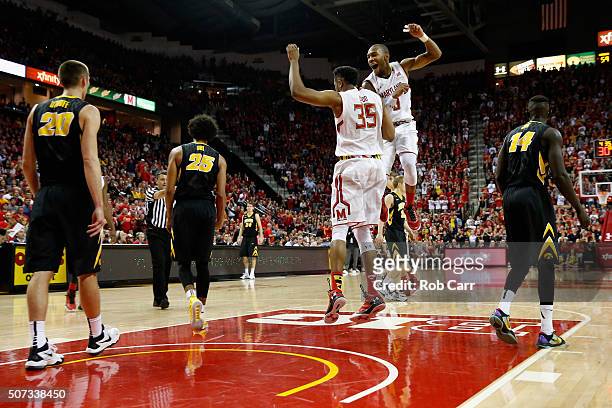Damonte Dodd and Rasheed Sulaimon of the Maryland Terrapins celebrate in the second half of their 74-68 win over the Iowa Hawkeyes at Xfinity Center...