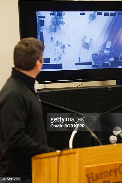 Special agent Greg Bretzing looks at a video of the shooting death of Robert "LaVoy" Finicum, as he addresses the public at the Harney County Chamber...