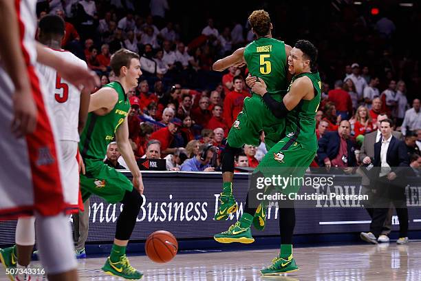 Dillon Brooks and Tyler Dorsey of the Oregon Ducks celebrate after defeating the Arizona Wildcats in the college basketball game at McKale Center on...