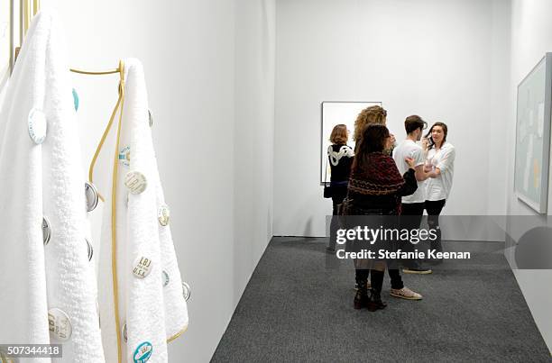 Guests attend the Art Los Angeles Contemporary 2016 Opening Night at Barker Hangar on January 28, 2016 in Santa Monica, California.