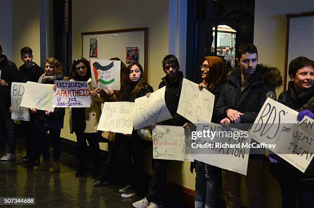 Protesters are seen outside the auditorium where actor Michael Douglas speaks with Israeli politician and activist Natan Sharansky about Jewish...