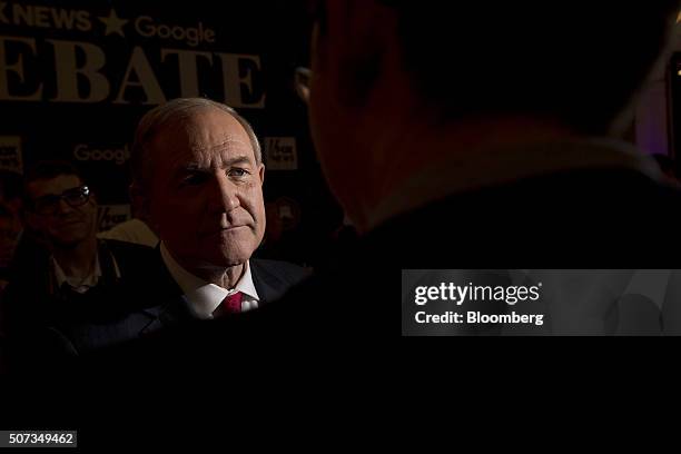 Jim Gilmore, former governor of Virginia and 2016 Republican presidential candidate, left, talks to a member of the media in the spin room following...