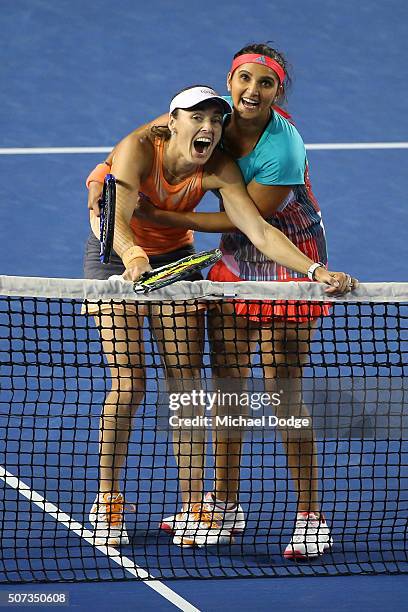 Martina Hingis of Switzerland and Sania Mirza of India react after a line review in their women's doubles final match against Andrea Hlavackova and...