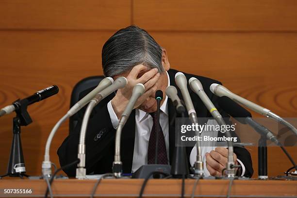 Haruhiko Kuroda, governor of the Bank of Japan , looks down at his notes during a news conference at the central bank's headquarters in Tokyo, Japan,...