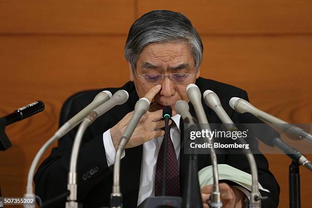 Haruhiko Kuroda, governor of the Bank of Japan , looks down at his notes while speaking during a news conference at the central bank's headquarters...