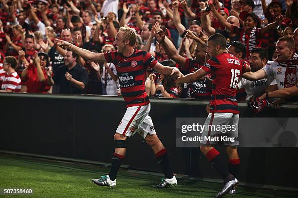 Mitch Nichols of the Wanderers celebrates with Jaushua Sotirio of the Wanderers and fans after scoring the first goal during the round 17 A-League...