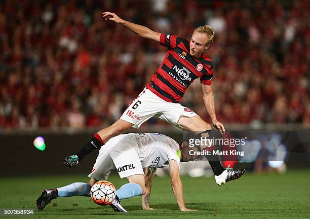 Mitch Nichols of the Wanderers competes for the ball against Anthony Careers of Melbourne City during the round 17 A-League match between the Western...