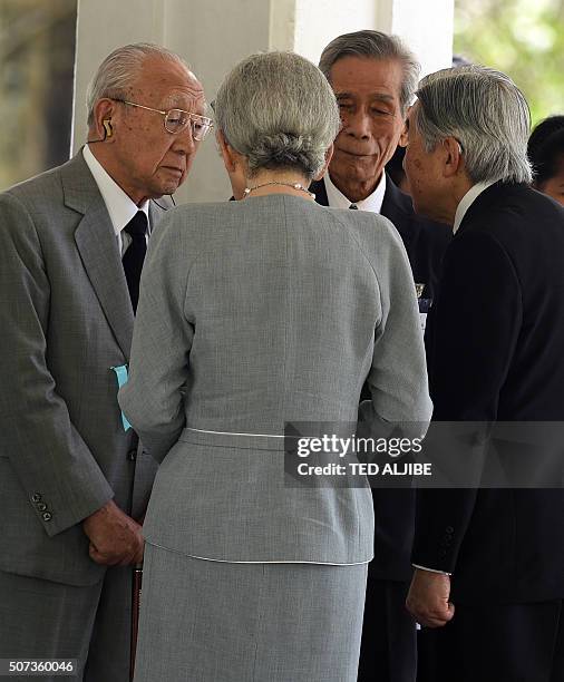 Japan's Emperor Akihito and Empress Michiko talk to former Japanese soldiers who served in World War II, during a visit to a memorial garden for...