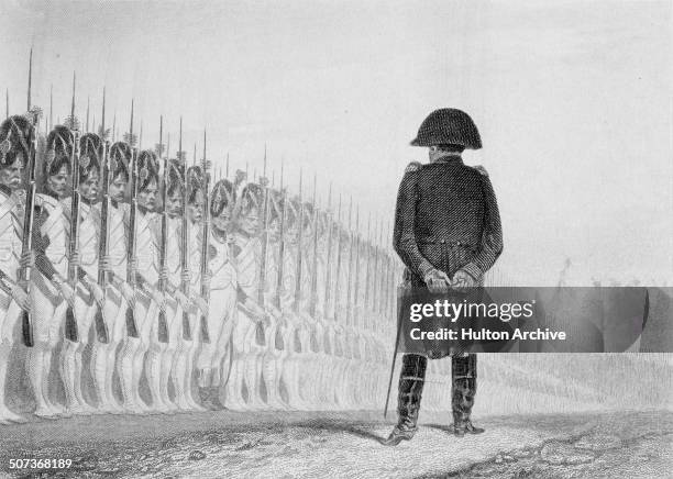 Napoleon Bonaparte as Emperor Napoleon 1 of France reviewing the Grenadiers of the Imperial Guard on 1 June 1811 in Paris, France. An engraving by...