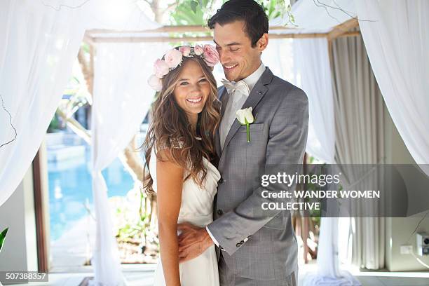 young couple getting married at wedding alter - wedding ceremony alter stock pictures, royalty-free photos & images