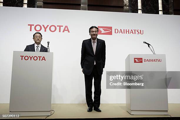 Masanori Mitsui, president of Daihatsu Motor Co., right, and Akio Toyoda, president of Toyota Motor Corp., attend a joint news conference in Tokyo,...
