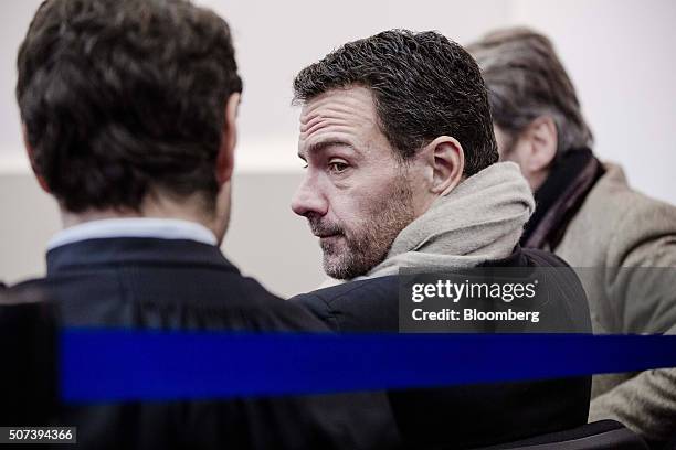 Jerome Kerviel, former trader for Societe Generale SA, center, sits with David Koubbi, a lawyer, left, inside Versailles courthouse in Versailles,...