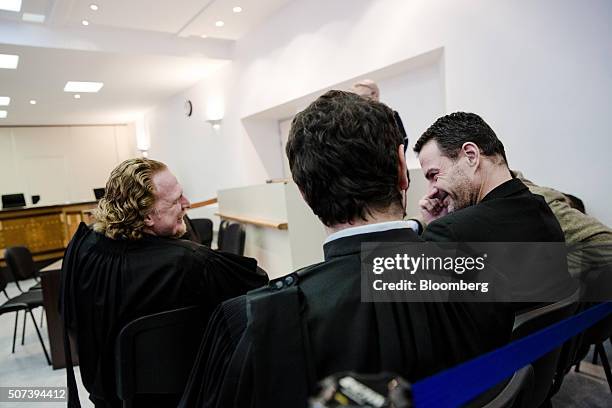 Jerome Kerviel, former trader for Societe Generale SA, right, reacts as he sits with David Koubbi, a lawyer, center, and Benoit Pruvost, a lawyer,...