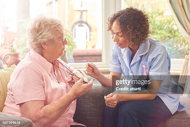 fall sensor pendant for senior woman - motion detector stock pictures, royalty-free photos & images