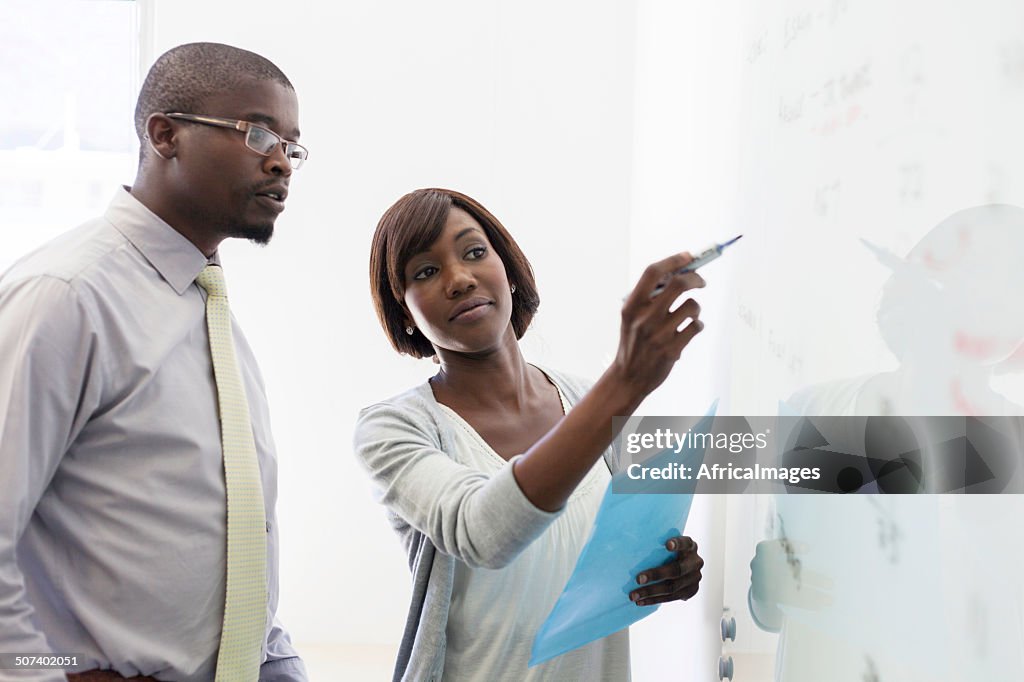 African business colleagues writing on the whiteboard