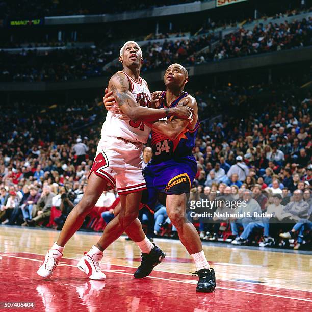 Dennis Rodman of the Chicago Bulls boxes out against Charles Barkley of the Phoenix Suns on January 28, 1996 at the United Center in Chicago,...