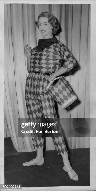 Pat O'Reilly models a 'jester' three piece playsuit in 'Everglaze', designed by Estrava, at a fashion display at the Dorchester Hotel, London,...