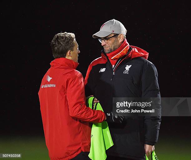 Jurgen Klopp manager of Liverpool talks with Lucas Leiva during a training session at Melwood Training Ground on January 29, 2016 in Liverpool,...