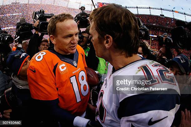 Quarterbacks Peyton Manning of the Denver Broncos and Tom Brady of the New England Patriots shake hands following the AFC Championship game at Sports...