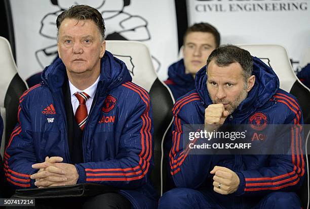 Manchester United's Dutch manager Louis van Gaal and Manchester United's Welsh assistant manager Ryan Giggs sit in the dug out ahead of the FA cup...