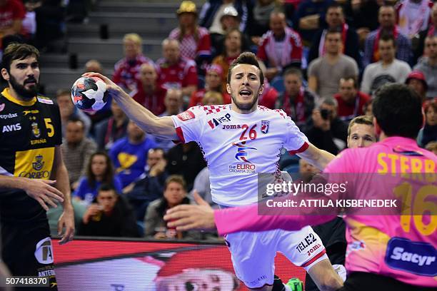 Manuel Strlek of Croatia scores a goal against goalkeeper Arpad Sterbik and Jorge Maqueda of Spain during the semi-final match of the Men's 2016 EHF...