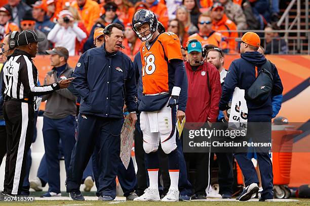 Head coach Gary Kubiak and quarterback Peyton Manning of the Denver Broncos talk during the AFC Championship game against the New England Patriots at...