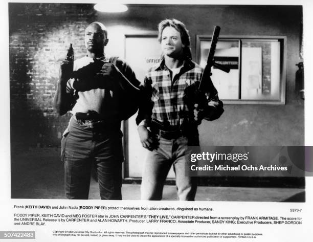 Keith David and Roddy Piper protest themselves from Alien creatures, disguised as humans in a scene from the Universal Studio movie "They Live",...
