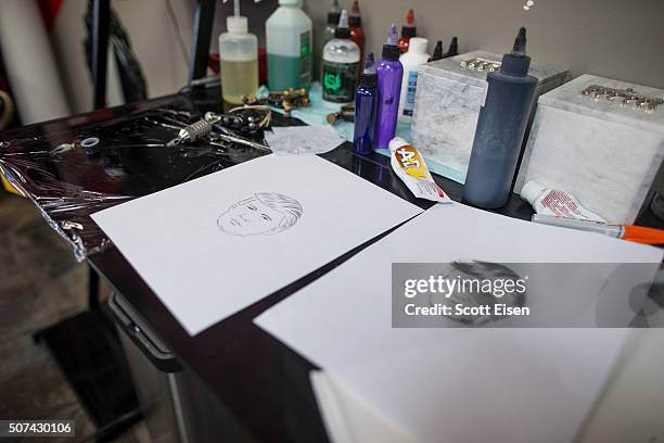 Drawings of Republican presidential candidate Donald Trump sit on a table at the Clay Dragon Tattoo shop on January 29, 2016 in Seabrook, New...