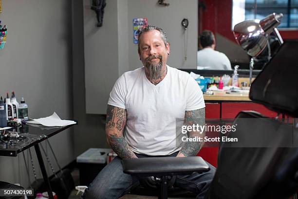 Bob Holmes, owner of The Clay Dragon Tattoo in his shop on January 29, 2016 in Seabrook, New Hampshire. Holmes is giving free Donald Trump tattoos to...