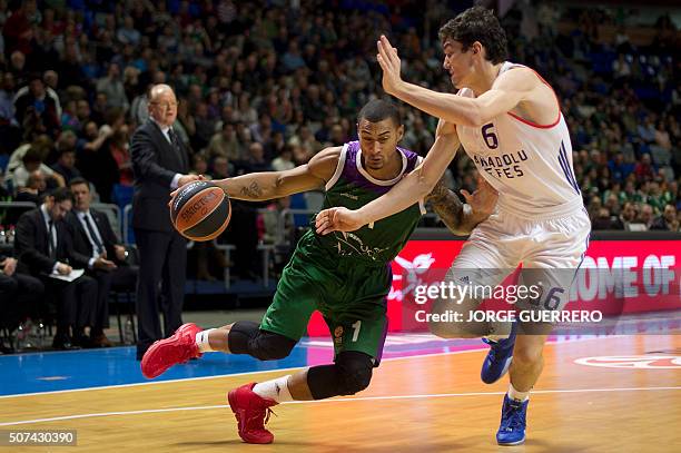 Unicaja's French guard Edwin Jackson vies with Anadolu Efes' Turkish forward Cedi Osman during the Euroleague group E top16 round 5 basketball match...