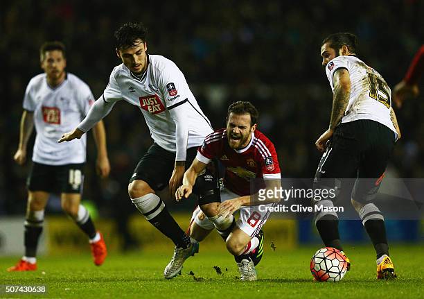 Juan Mata of Manchester United attempts to beat George Thorne and Bradley Johnson of Derby County during the Emirates FA Cup fourth round match...