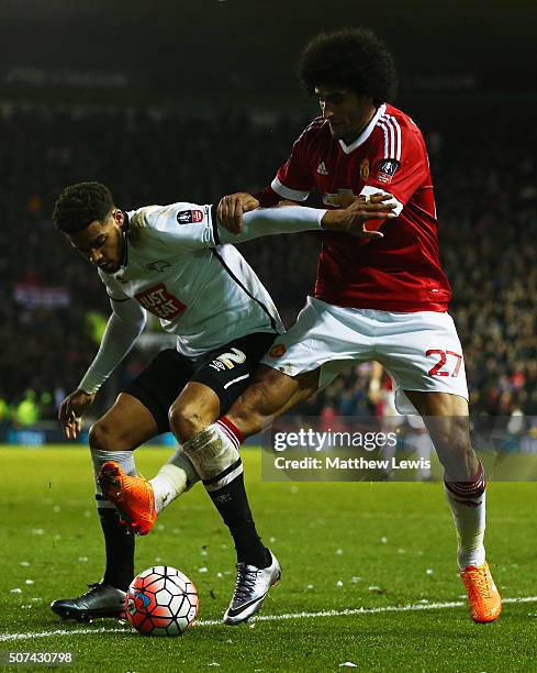 Cyrus Christie of Derby County holds off Marouane Fellaini of Manchester United during the Emirates FA Cup fourth round match between Derby County...