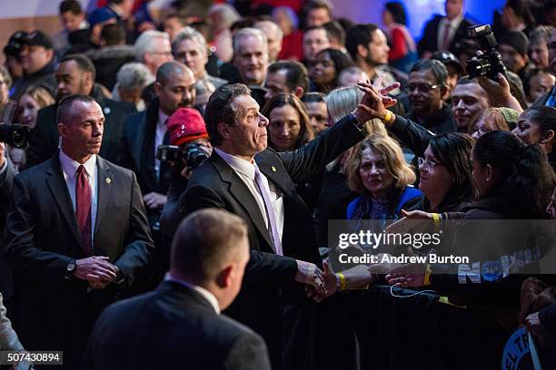 New York Governor Andrew Cuomo shakes hands with supporters after speaking at a rally for paid family leave on January 29, 2016 in New York City. The...