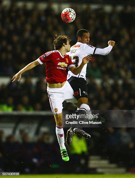 Daley Blind of Manchester United and Tom Ince of Derby County jump for the ball during the Emirates FA Cup fourth round match between Derby County...