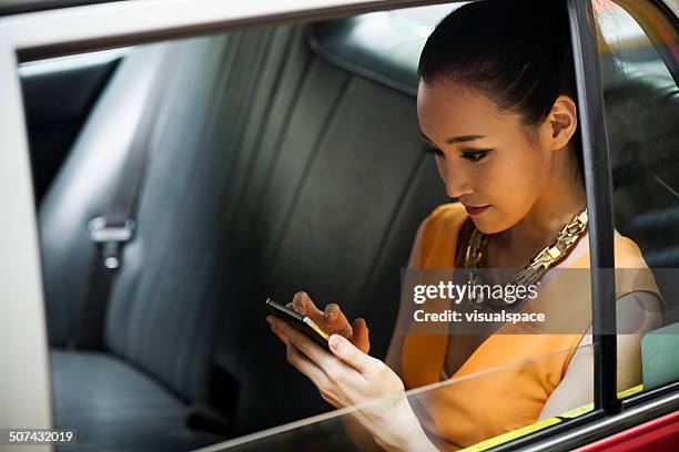 young woman in taxi - china smartphone stock pictures, royalty-free photos & images