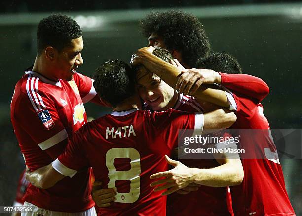 Daley Blind of Manchester United celebrates with Juan Mata and team mates as he scores their second goal during the Emirates FA Cup fourth round...