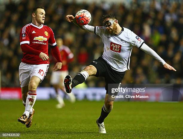 Richard Keogh of Derby County is watched by Wayne Rooney of Manchester United during the Emirates FA Cup fourth round match between Derby County and...