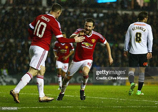 Juan Mata of Manchester United celebrates with Wayne Rooney as he scores their third goal during the Emirates FA Cup fourth round match between Derby...