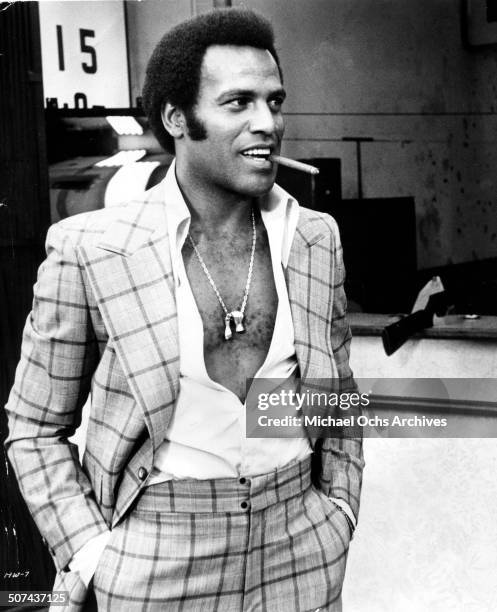 Fred Williamson as Jagger Daniels smokes a cigar in a scene from the movie"Three the Hard Way" , circa 1974.
