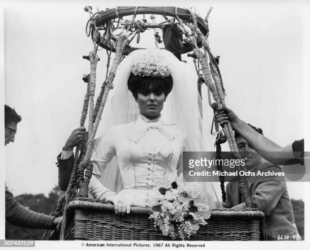 Daliah Lavi as Madelaine in a wedding dress as she takes off in a hot air balloon basket in a scene from the movie "Those Fantastic Flying Fools",...