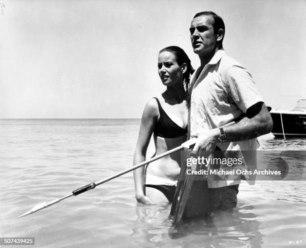 Sean Connery as James Bond protects Claudine Auger as Domino in a scene from the movie "Thunderball", circa 1965.