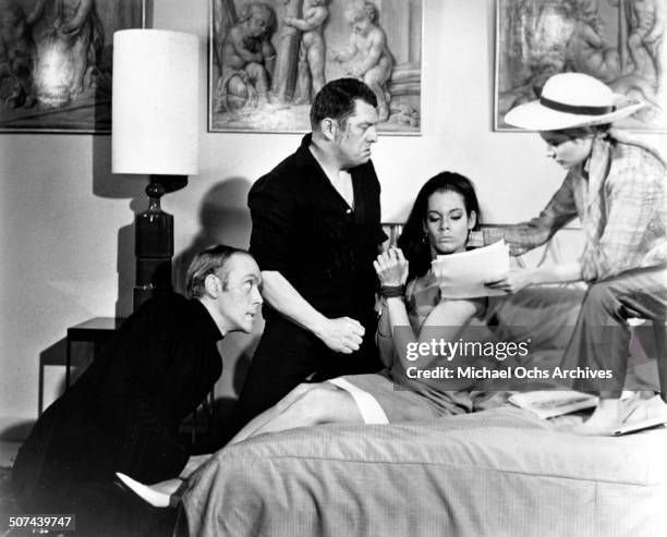 Philip Locke, Michael Brennan and Luciana Paluzzi persuade Martine Beswick in a scene from the movie "Thunderball", circa 1965.