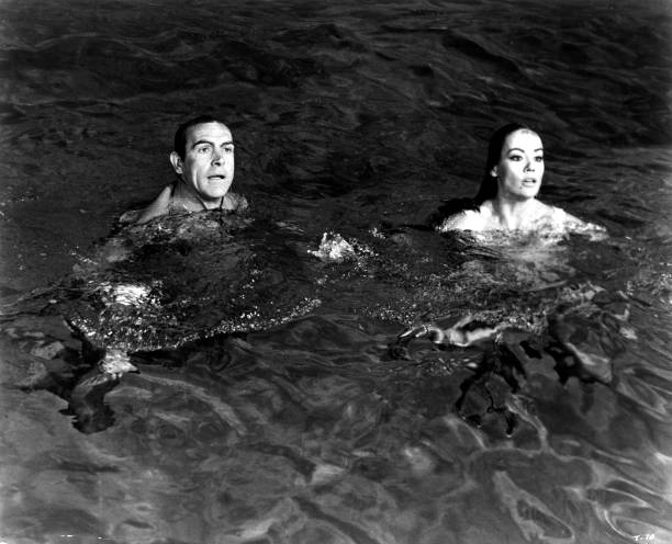Sean Connery as James Bond protects Claudine Auger as Domino in a scene from the movie "Thunderball", circa 1965.