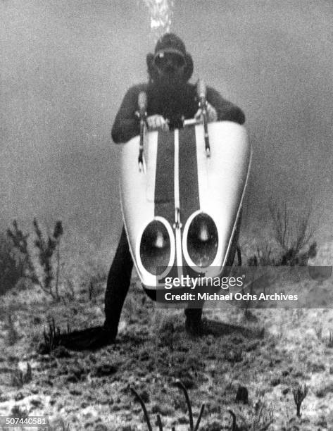 Sean Connery as James Bond swims with a scuba propeller in a scene from the movie "Thunderball", circa 1965.