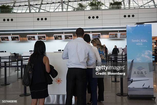 Travelers wait to check in for the Alas Uruguay inaugural flight to Buenos Aires at Montevideo Carrasco International Airport in Montevideo, Uruguay,...