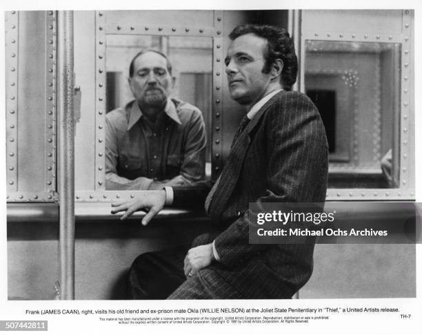 James Caan visits his old prison mate Willie Nelson in a scene from the United Artist movie "Thief", circa 1981.