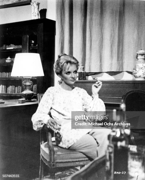 Caroline Cellier sits in a chair in a scene from the movie "This Man Must Die" , circa 1969.